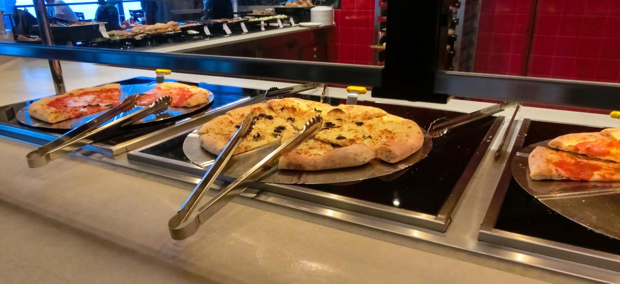 Dining Room Buffet aboard the abstract luxury cruise ship. Selective focus. pizza