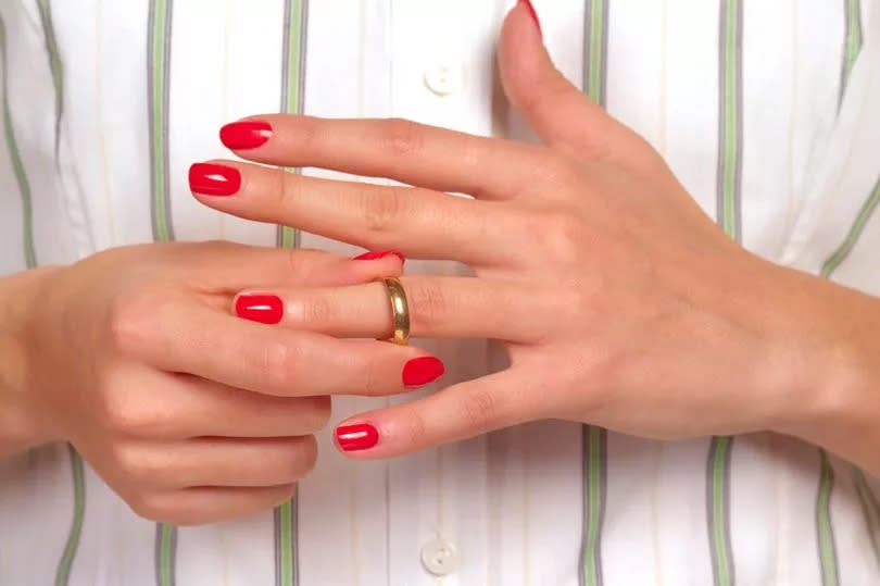 Woman taking wedding ring off