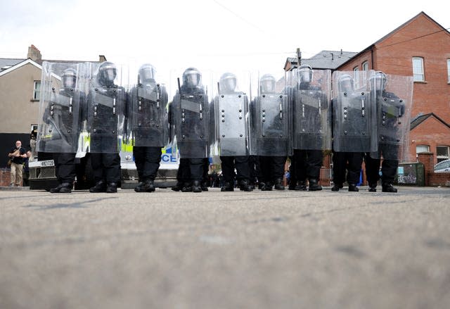 Line of police officers in protective gear