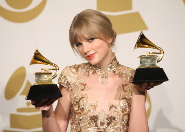<p> Taylor Swift shows off her wins at the Grammys on Feb. 12, 2012. Swift took home trophies for Best Country Song, Best Country Solo Performance and Best Country Album.</p><p>Michael Tran/FilmMagic</p>