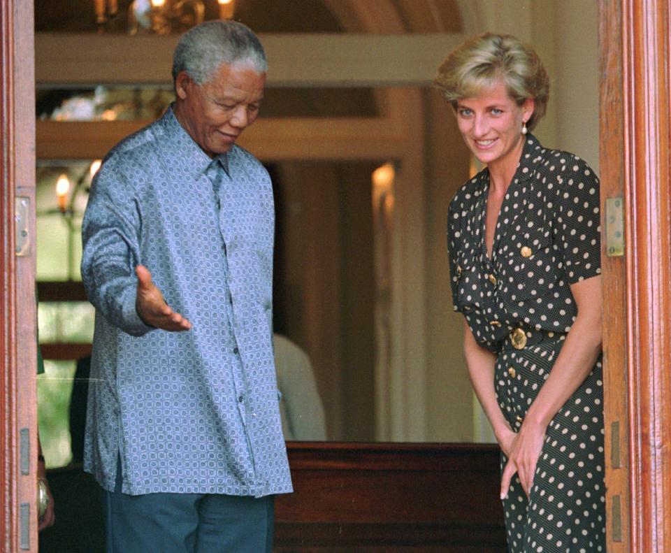 FILE - South African President Nelson Mandela, left, escorts Diana, Princess of Wales, during a courtesy visit to Mandela while visiting her brother, Earl Spencer, in Cape Town on March 17, 1997. Above all, there was shock. That’s the word people use over and over again when they remember Princess Diana’s death in a Paris car crash 25 years ago this week. The woman the world watched grow from a shy teenage nursery school teacher into a glamorous celebrity who comforted AIDS patients and campaigned for landmine removal couldn’t be dead at the age of 36, could she? (AP Photo/Sasa Kralj, File)