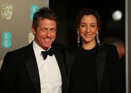 FILE PHOTO - Hugh Grant and Anna Eberstein arrive for the British Academy of Film and Television Awards (BAFTA) at the Royal Albert Hall in London, Britain, February 18, 2018. REUTERS/Hannah McKay