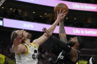 Utah Jazz forward Kelly Olynyk, left, blocks Los Angeles Clippers forward Marcus Morris Sr., right, during the second half of an NBA basketball game Wednesday, Nov. 30, 2022, in Salt Lake City. (AP Photo/Rick Bowmer)