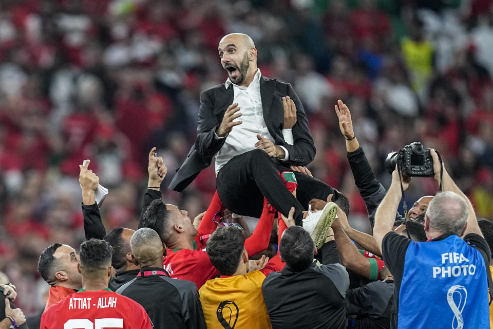 Morocco's head coach Walid Regragui celebrate at the end of the World Cup quarterfinal soccer match between Morocco and Portugal, at Al Thumama Stadium in Doha, Qatar, Saturday, Dec. 10, 2022. (AP Photo/Ariel Schalit)