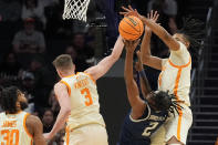 Tennessee guard Dalton Knecht, left, and forward Jonas Aidoo block a shot by Saint Peter's guard Marcus Randolph during the first half of a first-round college basketball game in the NCAA Tournament, Thursday, March 21, 2024, in Charlotte, N.C. (AP Photo/Chris Carlson)