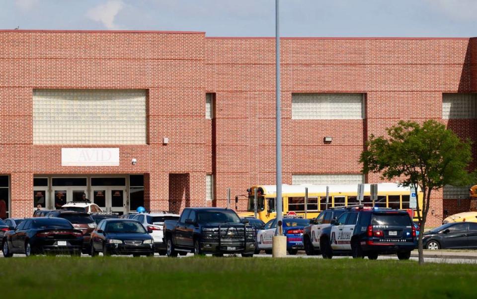 Buses line up in front of Bowie High School in Arlington on Wednesday, April 24, 2024. Parents and family were told to pick up students at a reunification site at the Arlington ISD Athletics Center following a shooting outside the school’s campus.