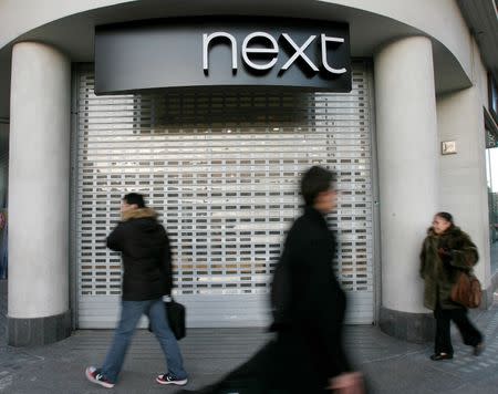 Pedestrians walk past a Next shop in Oxford Street in London January 6, 2009. REUTERS/Andrew Winning