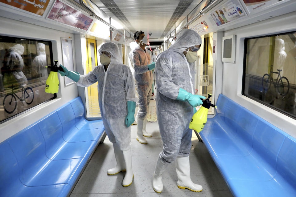 Workers disinfect subway trains against coronavirus in Tehran, Iran, in the early morning of Wednesday, Feb. 26, 2020. Iran's government said Tuesday that more than a dozen people had died nationwide from the new coronavirus, rejecting claims of a much higher death toll of 50 by a lawmaker from the city of Qom that has been at the epicenter of the virus in the country. (AP Photo/Ebrahim Noroozi)