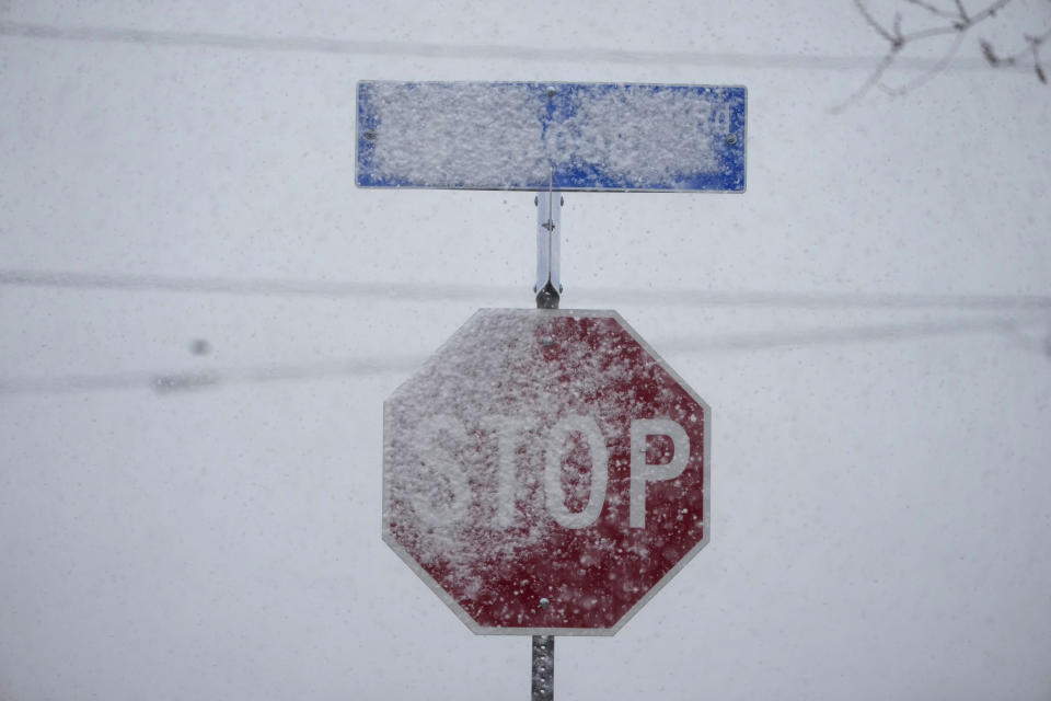 A stop sign is covered during a snow storm, Wednesday, March 1, 2023, in Elizabeth Lake, Calif., about 70 miles north of Los Angeles. (AP Photo/Marcio Jose Sanchez)