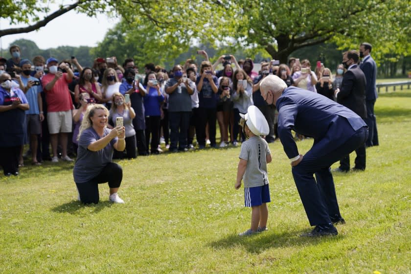 President Joe Biden stops outside at York High School and is greeted by a boy and his mother, Monday, May 3, 2021, in Yorktown, Va. (AP Photo/Evan Vucci)