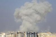 Smoke rises after what activists said was an airstrike by forces loyal to Syria's President Bashar al-Assad in Raqqa, eastern Syria, which is controlled by the Islamic State November 19, 2014. REUTERS/Nour Fourat