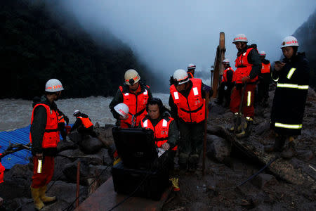 Paramilitary police work at the site of a landslide in Sanming, Fujian Province, China, May 8, 2016. China Daily/via REUTERS