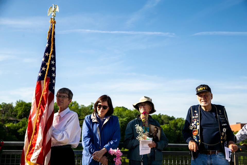 Community members attend a ceremony in memory of soldiers and sailors lost at sea on Memorial Day, Monday, May 29, 2023, at Park Road Bridge in Iowa City, Iowa.