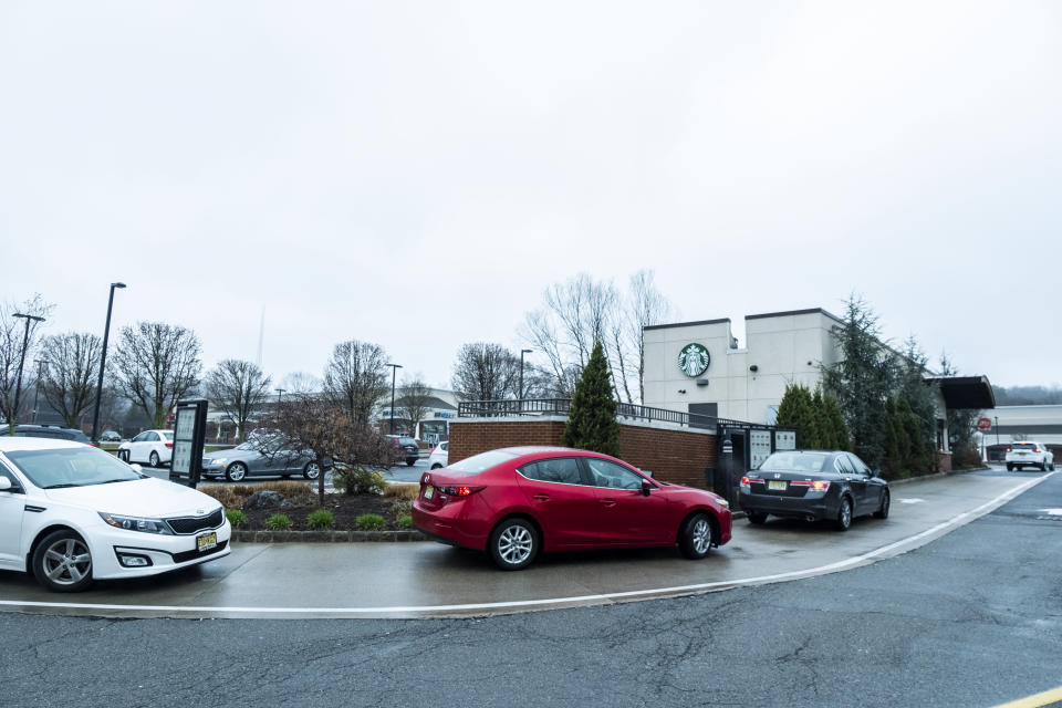 POMPTON LAKES, NJ - MARCH 29: A line of cars waits at Starbucks Drive Thru which his closed its cafe and is only operating their drive-thru from 6 AM to 2 PM on a Sunday afternoon.  Earlier in the week Governor Phil Murphy announced a total 24-hour lockdown of the New Jersey residents after they did not take his stay-at-home orders seriously regarding the Coronavirus pandemic.  The Governor also issued a statement saying that those that did not heed this would be prosecuted. Photographed in Pompton Lakes, NJ on March 29, 2020, USA.  (Photo by Ira L. Black/Corbis via Getty Images)