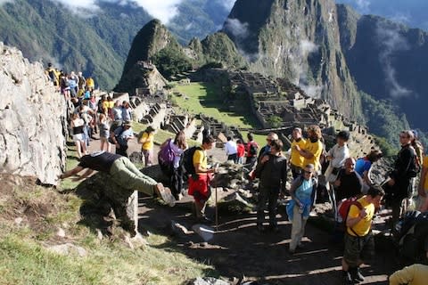 Confused tourists mull over whether planking man is part of Incan ruins