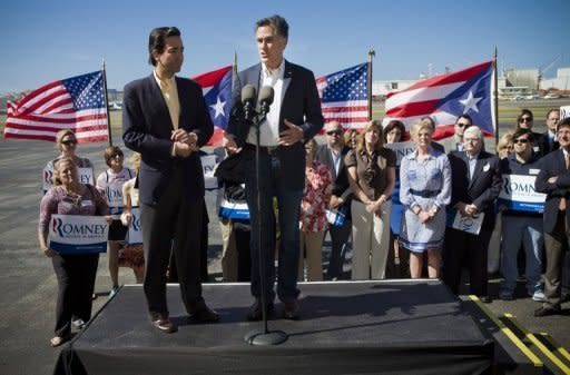 Presidential candidate and former Massachusetts Gov. Mitt Romney (R) speaks as Puerto Rico Gov. Luis Fortuno listens at Isla Grande Airport on March 16, in San Juan, Puerto Rico. Romney got off to a big early lead Sunday in the US territory of Puerto Rico's Republican primary