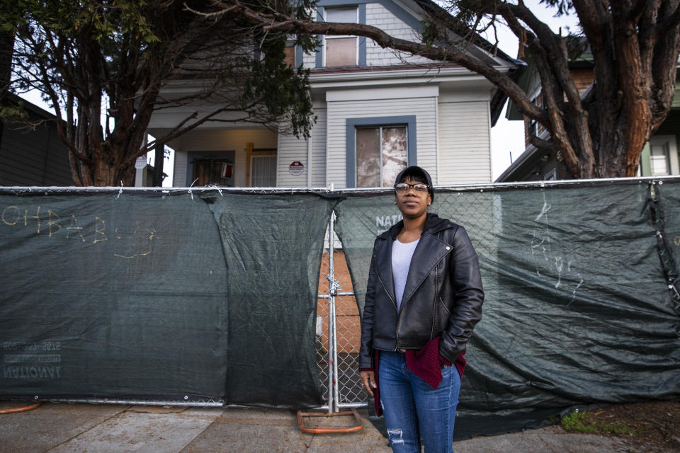 Moms 4 Housing activist Misty Cross stands for a portrait in front of the now fenced off vacant home that she and other homeless or insecurely housed mothers occupied during a months-long protest which ended in a court ordered eviction, in Oakland, California on January 28, 2020. - When Dominique Walker moved back from Mississippi to her native California last year, she planned to pursue a nursing degree while caring for her two small children. But she and other moms and their children ended up living as squatters in a bold, high-profile protest against homelessness. According to city officials, an estimated 4,071 people were living on the street, in shelters or in their cars in 2019 in Oakland, a 47 percent increase in two years. (Photo by Philip Pacheco / AFP) (Photo by PHILIP PACHECO/AFP via Getty Images)