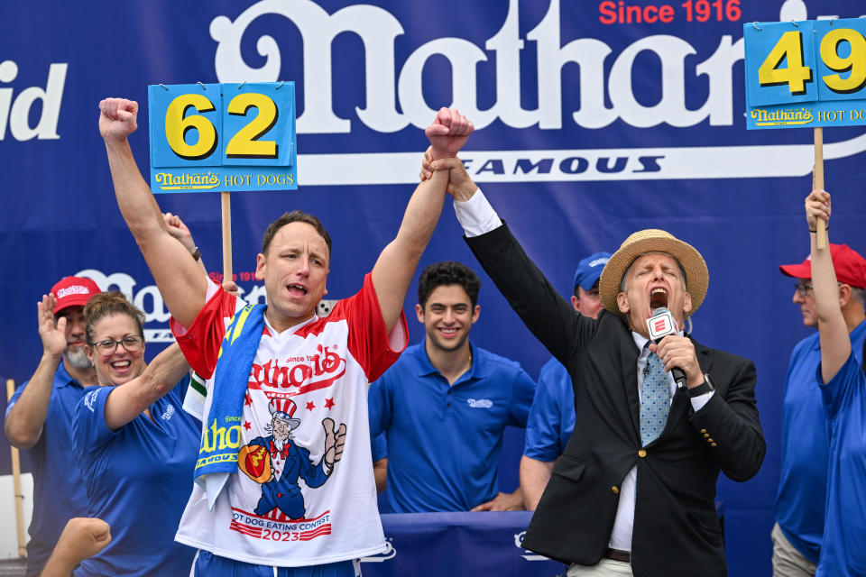Defending champion Joey Chestnut cheers after finishing in first place in the Nathan's Famous Fourth of July International Hot Dog Eating Contest on July 4, 2023, at Coney Island in the Brooklyn borough of New York City. / Credit: Alexi J. Rosenfeld/Getty Images