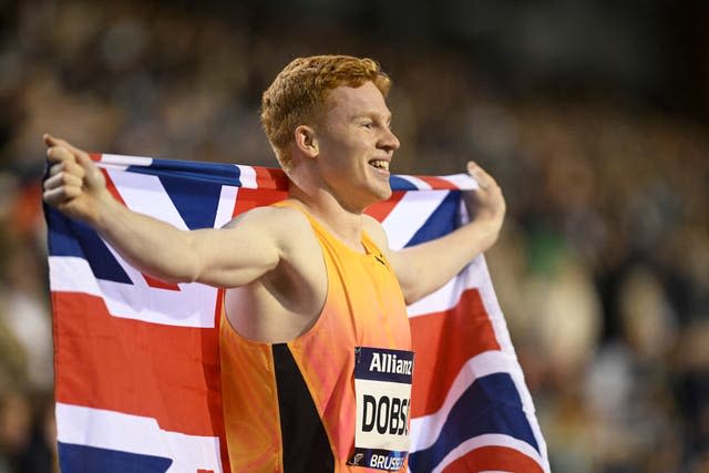 Charles Dobson, of Great Britain. poses with the Union Jack after winning the men’s 400 meters during the Diamond League final 2024 athletics meet in Brussels