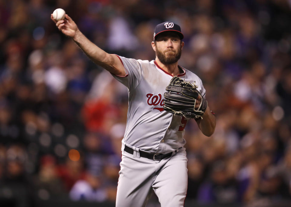 Washington Nationals relief pitcher Greg Holland throws to first base to put out Colorado Rockies' DJ LeMahieu in the eighth inning of a baseball game Saturday, Sept. 29, 2018, in Denver. (AP Photo/David Zalubowski)