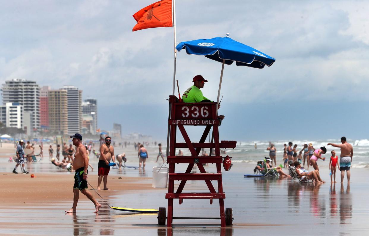 A Volusia County lifeguard keeps watch on swimmers, Monday, June 27, 2022, in front of the Ocean Walk Resort.