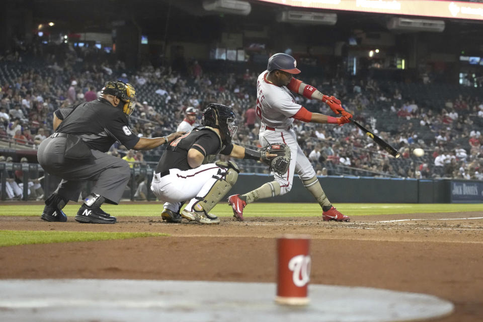 Washington Nationals center fielder Victor Robles (16) hits an RBI single against the Washington Nationals during the second inning of a baseball game Saturday, May 15, 2021, in Phoenix. (AP Photo/Rick Scuteri)