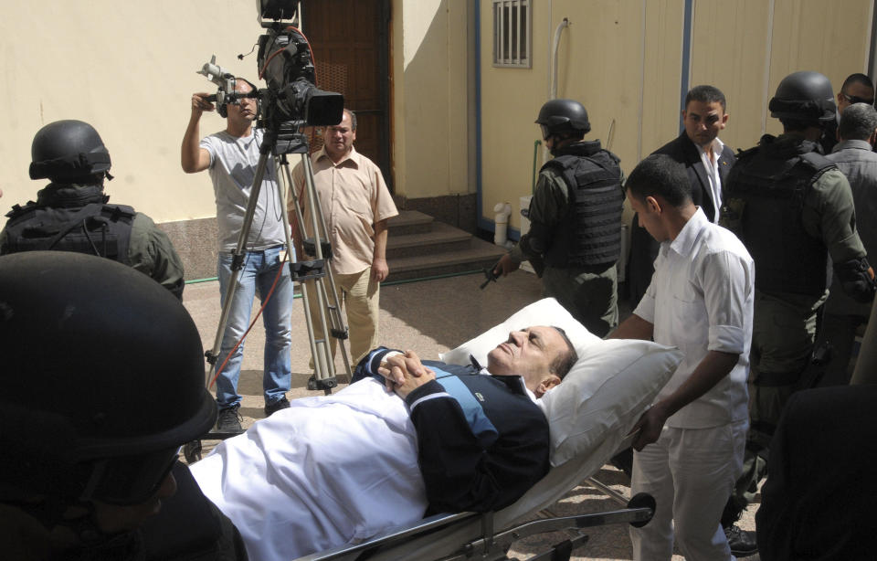 FILE - In this Sept. 7, 2011 file photo, former Egyptian president Hosni Mubarak lies on a gurney bed while being taken to the courtroom for another session of his trial in Cairo, Egypt's State TV said Tuesday, Feb. 25, 2020, that Mubarak, who was ousted in the 2011 Arab Spring uprising, has died at 91. Mubarak ruled the most populous Arab country for nearly three decades, serving as a loyal U.S. ally against Islamic militancy and assisting regional peace efforts. But his autocratic rule grew increasingly unpopular in his later years, and he was forced to resign on Feb. 11, 2011, after 18 days of mass protests. (AP Photo, File)