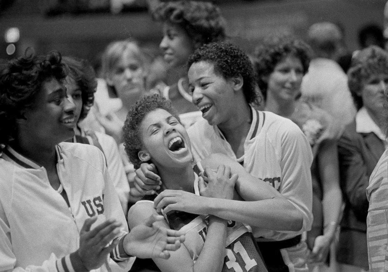University of Southern California's Cheryl Miller, left, and Cynthia Cooper rejoice after winning the NCAA Women's Basketball Championship by defeating the University of Tennessee 72-61 in Los Angeles, April 1, 1984. Miller was named MVP of the tournament. The win was the second consecutive championship win for the USC Trojans. (AP Photo/Lennox McLendon)