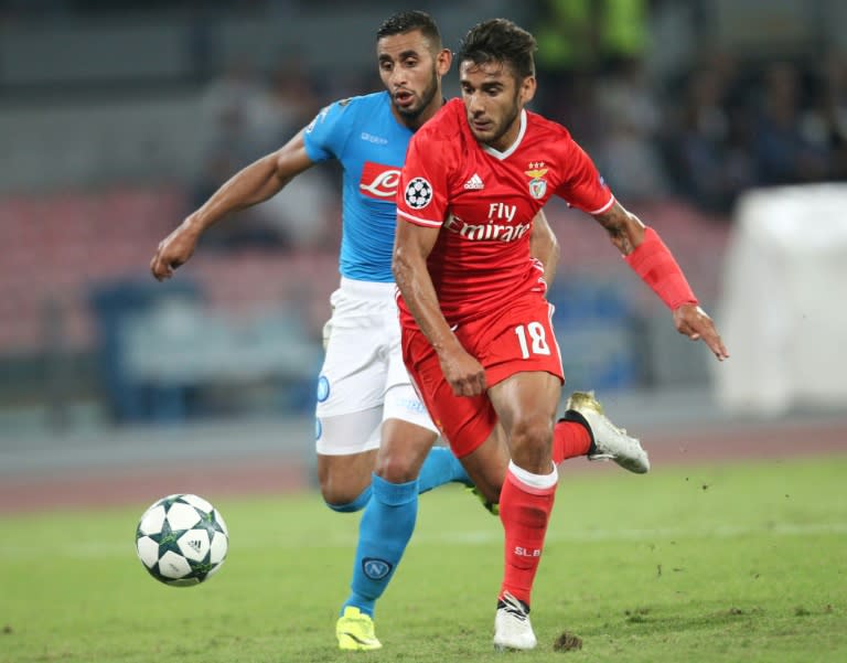 Benfica's Eduardo Salvio (R) scores against Napoli during the UEFA Champions League match at the San Paolo stadium in Naples