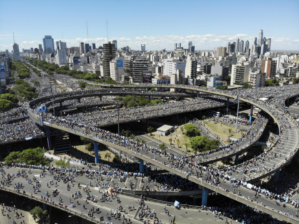 Argentina soccer fans converge on the highways during a homecoming parade for the players who won the World Cup title, in downtown Buenos Aires, Argentina, Tuesday, Dec. 20, 2022. (AP Photo/Mario De Fina)