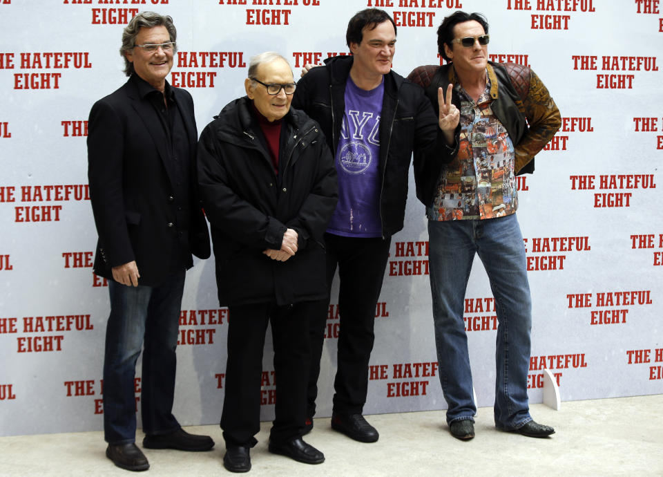 FILE - In this Jan. 28, 2016 file photo, from left, actor Kurt Russell, Italian composer Ennio Morricone, director Quentin Tarantino and actor Michael Madsen pose for photographers during a photo call of the movie The Hateful Eight, in Rome. Morricone, who created the coyote-howl theme for the iconic Spaghetti Western “The Good, the Bad and the Ugly” and the soundtracks such classic Hollywood gangster movies as “The Untouchables,” died Monday, July 6, 2020 in a Rome hospital at the age of 91. (AP Photo/Gregorio Borgia, file)