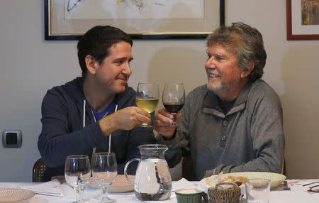 Daniel Vecino (L) and his father Rafael, who are in support of and against Catalan independence from Spain respectively, toast each other at the family home in Sant Cugat del Valles, a region of Catalonia, where a symbolic independence vote is being held, November 8, 2014. REUTERS/Gustau Nacarino