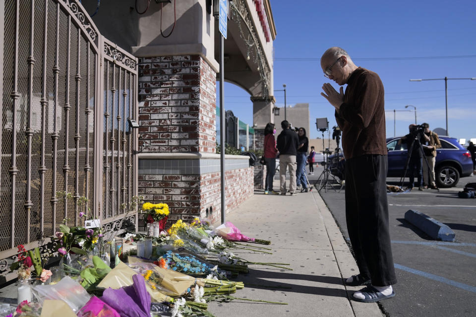 Kenny Loo, 71, prays outside Star Dance Studio for the victims killed in Saturday's shooting in Monterey Park, Calif., Monday, Jan. 23, 2023. Authorities searched for a motive for the gunman who killed 10 people at the ballroom dance club during Lunar New Year celebrations, slayings that sent a wave of fear through Asian American communities and cast a shadow over festivities nationwide. (AP Photo/Jae C. Hong)