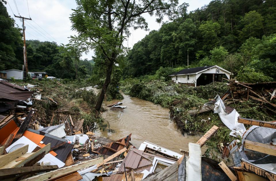 Debris from destroyed homes pile up near a concrete bridge over Grapevine Creek in Perry County after torrential rain caused flash flooding in Eastern Kentucky Thursday morning.  July 28, 2022