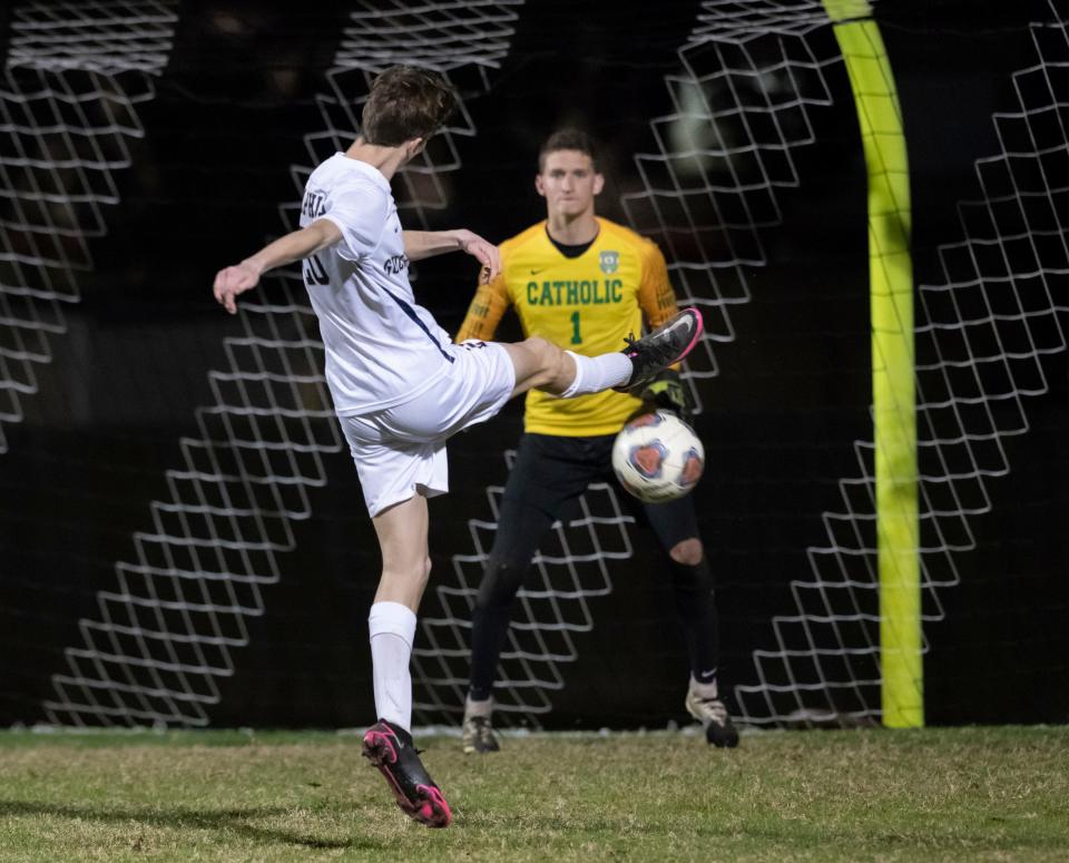 Carson Dahlem (20) takes a shot on goal during the Gulf Breeze vs Catholic boys soccer game at Pensacola Catholic High School on Wednesday, Dec. 8, 2021.