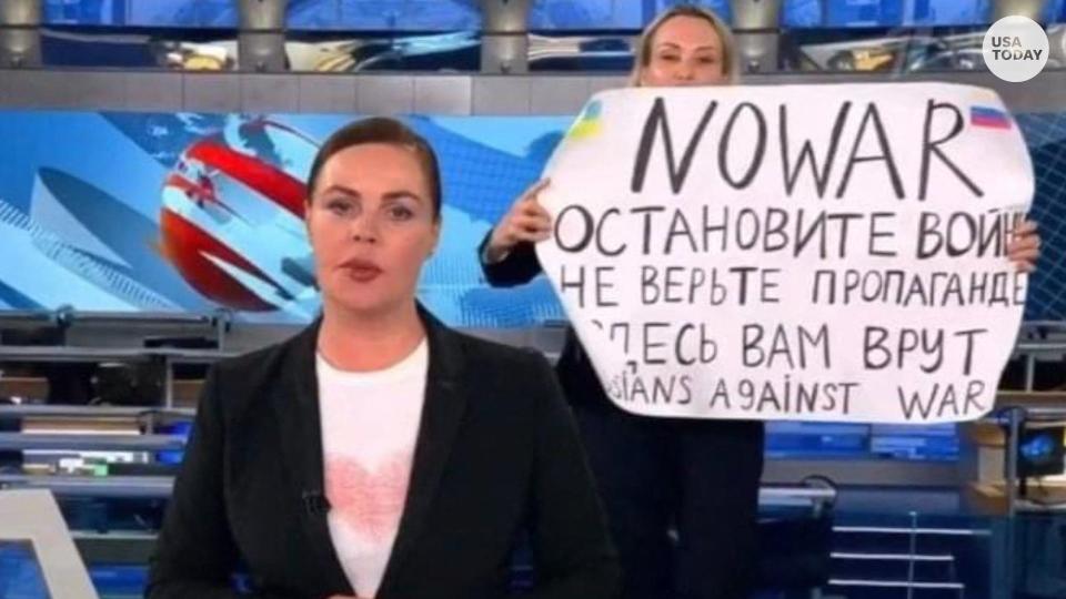 Marina Ovsyannikova holds a poster reading 