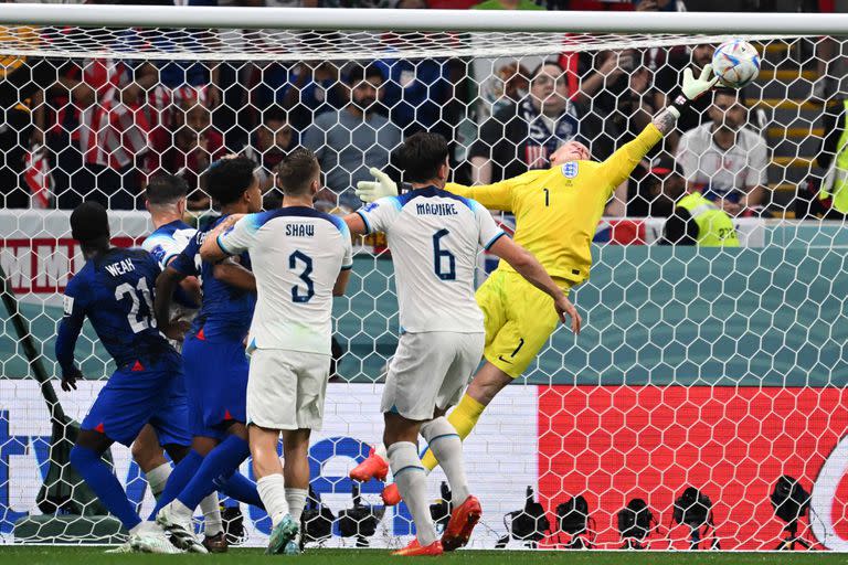 England's goalkeeper #01 Jordan Pickford dives to make a save during the Qatar 2022 World Cup Group B football match between England and USA at the Al-Bayt Stadium in Al Khor, north of Doha on November 25, 2022. (Photo by Kirill KUDRYAVTSEV / AFP)