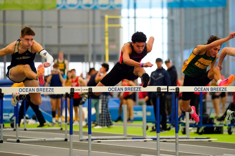 Joziah Johnson of Parsippany, center, competes in the 55-meter hurdles during the Morris County winter track championships at the Ocean Breeze Athletic Complex in Staten Island on Jan. 30, 2023.