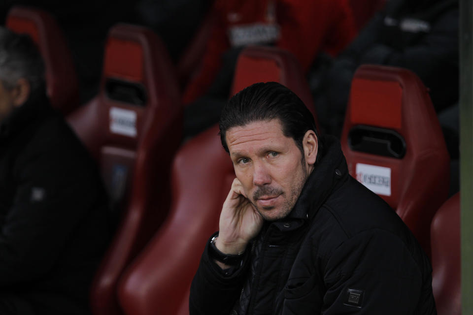 Atletico's coach Diego Simeone awaits the start of the Spanish La Liga soccer match between Atletico Madrid and Valladolid at the Vicente Calderon stadium in Madrid, Spain, Saturday, Feb. 15, 2014. (AP Photo/Gabriel Pecot)