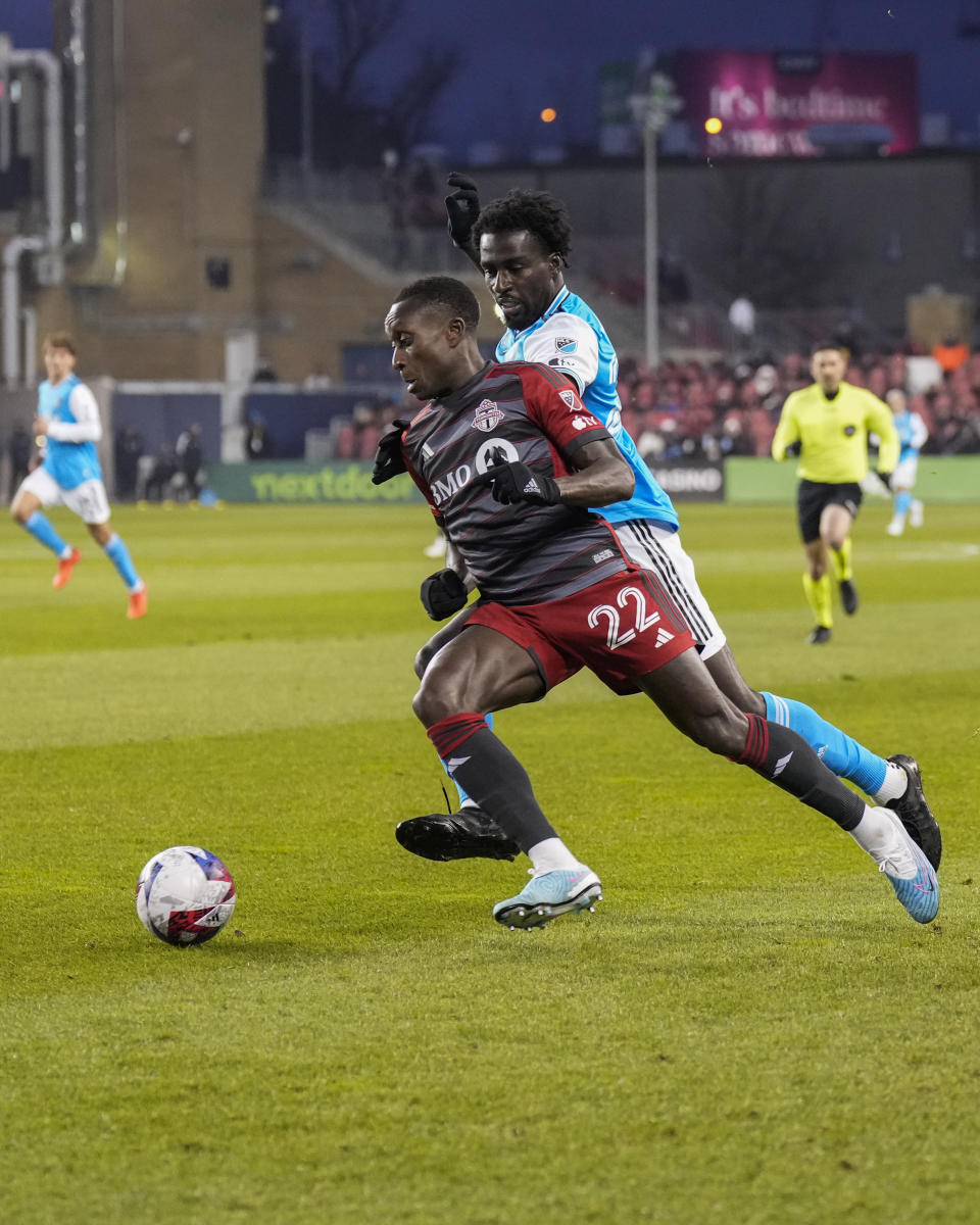 Toronto FC midfielder Richie Laryea (22) plays the ball against Charlotte FC midfielder Derrick Jones during the first half of an MLS soccer match Saturday, April 1, 2023, in Vancouver, British Columbia. (Andrew Lahodynskyj/The Canadian Press via AP)