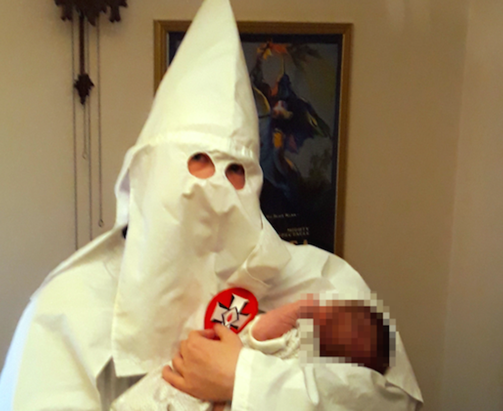 A picture shown to jurors allegedly showing Adam Thomas posing with his newborn baby while wearing Ku Klux Klan robes (Picture: PA)