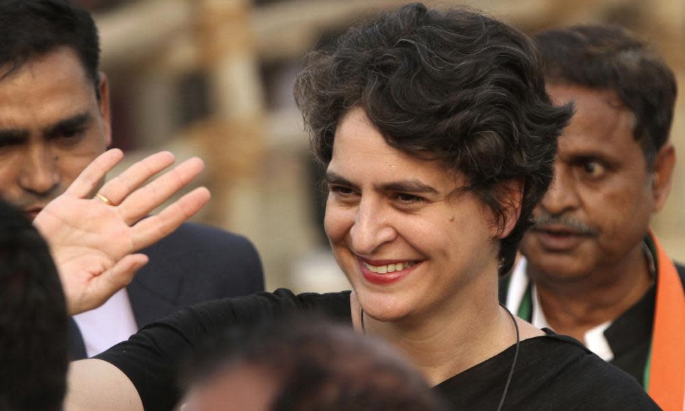 Priyanka Gandhi waves to party supporters during an election campaign rally