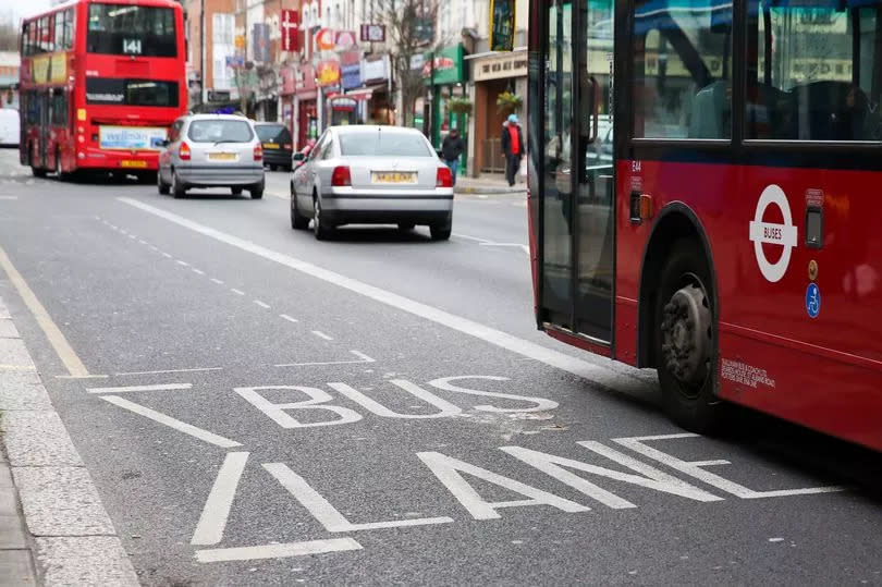 London buses on a street with a bus lane in place