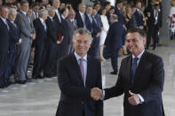 Brazil's President Jair Bolsonaro, right, shakes hands with Argentina's President Mauricio Macri, during a meeting at the Planalto presidential palace, in Brasilia, Brazil, Wednesday, Jan. 16, 2019. Macri is on a one-day visit to Brazil. (AP Photo/Eraldo Peres)