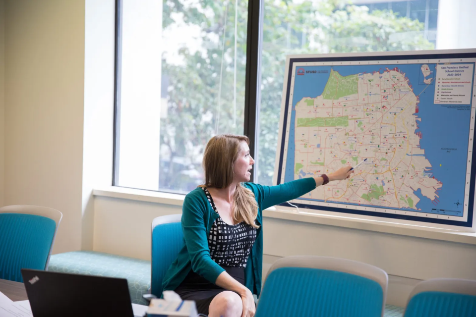 Lauren Koehler, executive director of San Francisco Unified School District’s enrollment center, points out district schools that a family has yet to consider in a counseling session two days before the 2023-24 school year begins. (Sonya Abrams/The Hechinger Report)