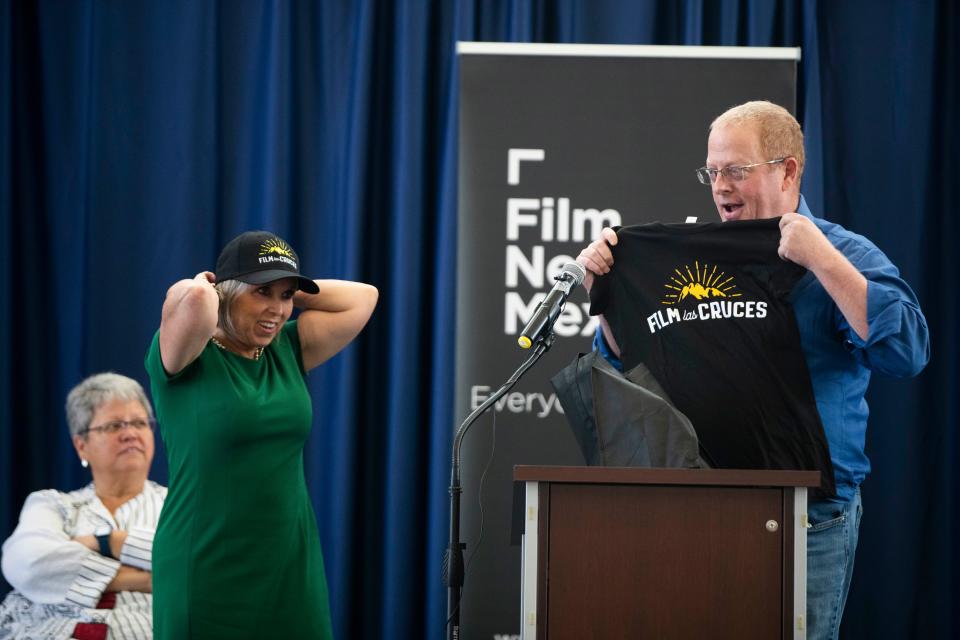 New Mexico Gov. Michelle Lujan Grisham, left, receives Film Las Cruces swag from state Sen. Jeff Steinborn, president of Film Las Cruces, right, during the satellite film school announcement at Doña Ana Community College on Tuesday, July 26, 2022.