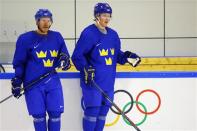 Sweden's Daniel Alfredsson (L) and Nicklas Backstrom participate in a men's ice hockey team practice at the 2014 Sochi Winter Olympics February 20, 2014. REUTERS/Brian Snyder