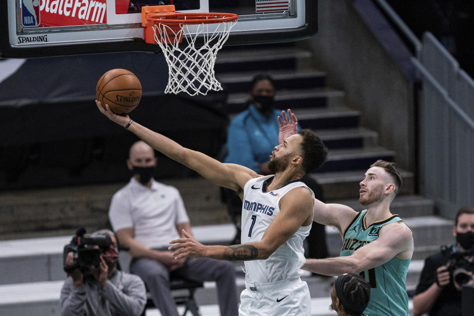 Memphis Grizzlies forward Kyle Anderson (1) lays up the ball past Charlotte Hornets forward Gordon Hayward during the first half of an NBA basketball game in Charlotte, N.C., Friday, Jan. 1, 2021. (AP Photo/Jacob Kupferman)