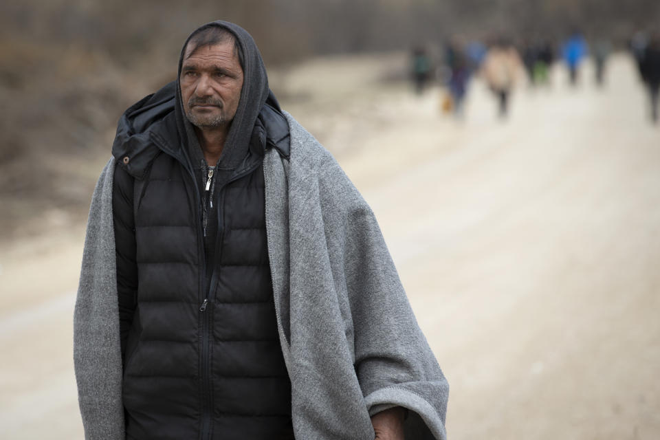 A migrant walks towards Croatian border in Lipa near Bihac, Western Bosnia, Wednesday, April 21, 2021. A senior U.N. migration official on Wednesday urged respect of international standards and an end to any abuse against migrants and refugees crossing borders while searching for a better future. The Chief of Staff of the International Organization for Migration, Eugenio Ambrosi, called on governments to correct any wrongdoing affecting people fleeing war and poverty. (AP Photo/Darko Bandic)