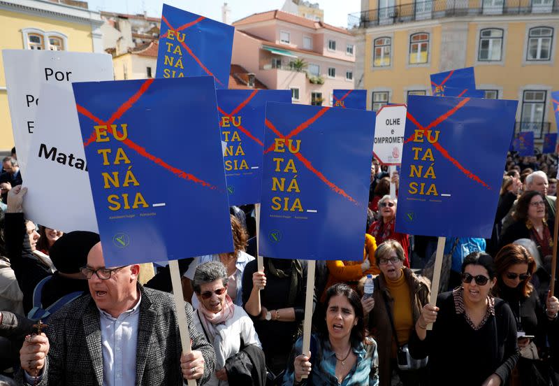 Demonstrators protest against euthanasia before a vote at the Portuguese parliament in Lisbon